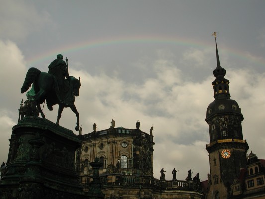 Old city plaza with rainbow